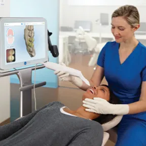 Dental assistant performing a digital scan of the teeth