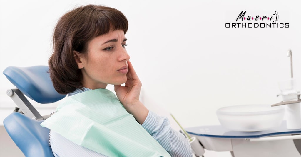 Nervous woman sitting in a dental chair at Masri Orthodontics